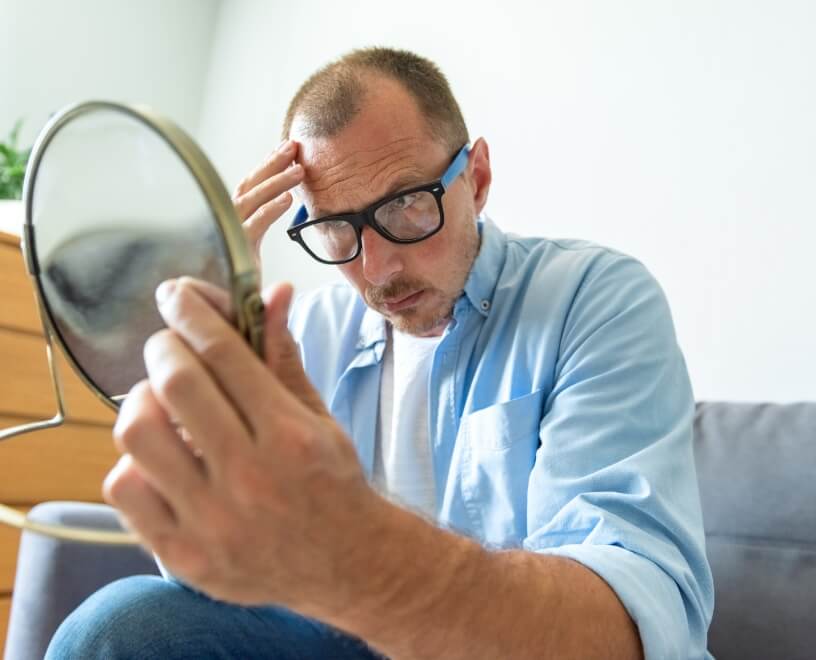 a-worried-white-man-looks-at-himself-in-the-mirror-2023-11-27-05-12-23-utc (1)